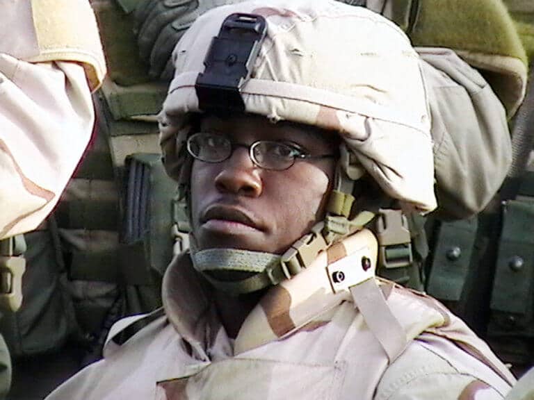 Military service member wearing protective equipment in an operational environment.